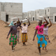 Women carry bricks at the construction site of real estate company Sipim in Grand Bassam, Ivory Coast. They are paid 25 West African francs (about $0.04) for each brick.